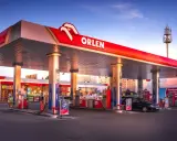 Stacja Orlen z dystrybutorami verva diesel i benzyny. W tle McDonald's i budynki mieszkalne.