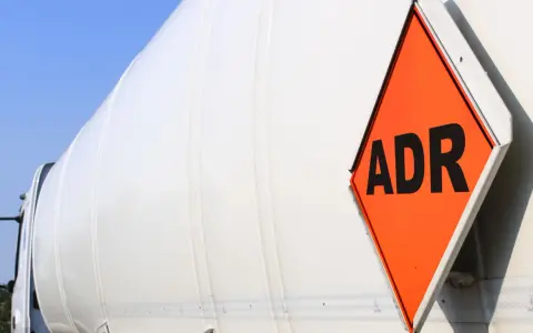 Pomarańczowa tablica ADR na białym cysternie. Zastanawiasz się, ile trwa kurs ADR?