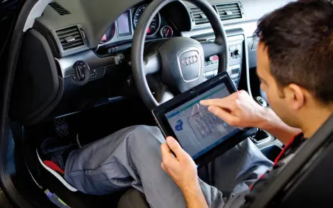 Mechanik sprawdza diagnostykę auta na tablecie. To ważny krok po zakupie auta, by upewnić się, że wszystko działa poprawnie.