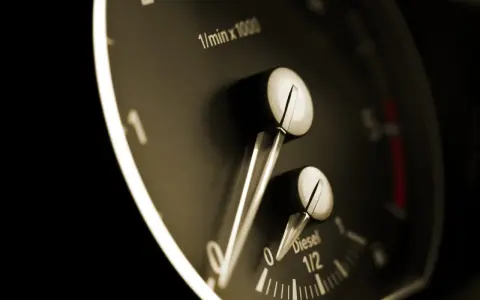 Zbliżenie na deskę rozdzielczą: wskaźnik paliwa Diesel na 1/2, obok obrotomierz.