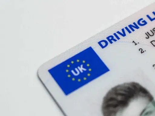 Brytyjskie prawo jazdy. Czy można jeździć oczekując na wymianę prawo jazdy? Dokument z flagą UK.