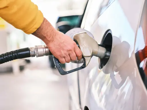 Dłoń tankuje samochód. Czy to tsi silnik benzyna czy diesel?