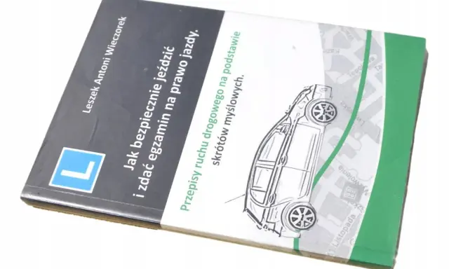 Książka "Jak bezpiecznie jeździć i zdać egzamin na prawo jazdy" z rysunkiem samochodu i mapą.